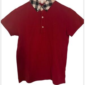 Burberry red polo shirt with iconic check collar detail.